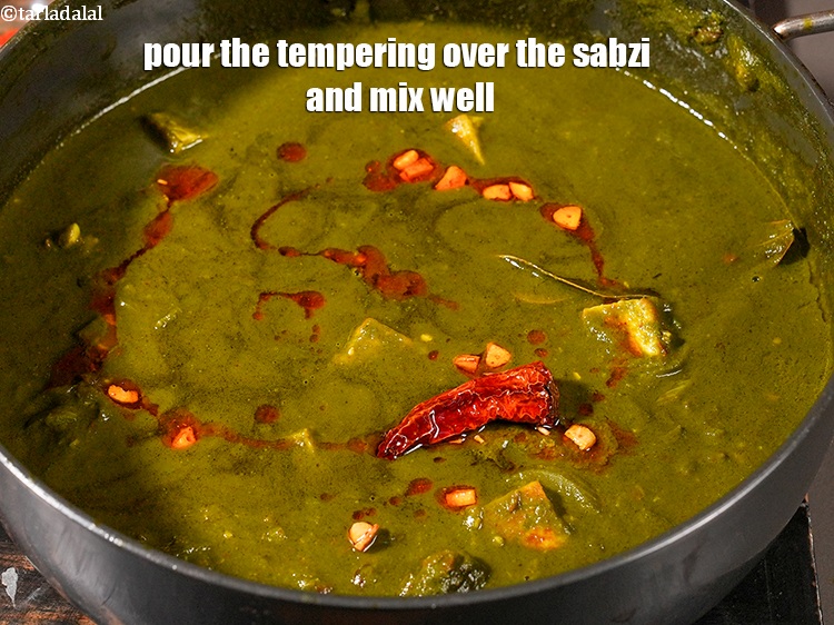 Step 51 – Pour the tempering over the sabzi and mix well.
