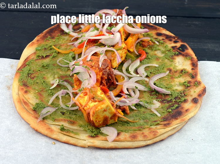 Step 57 – Place &frac14; th of the laccha onions.&nbsp;