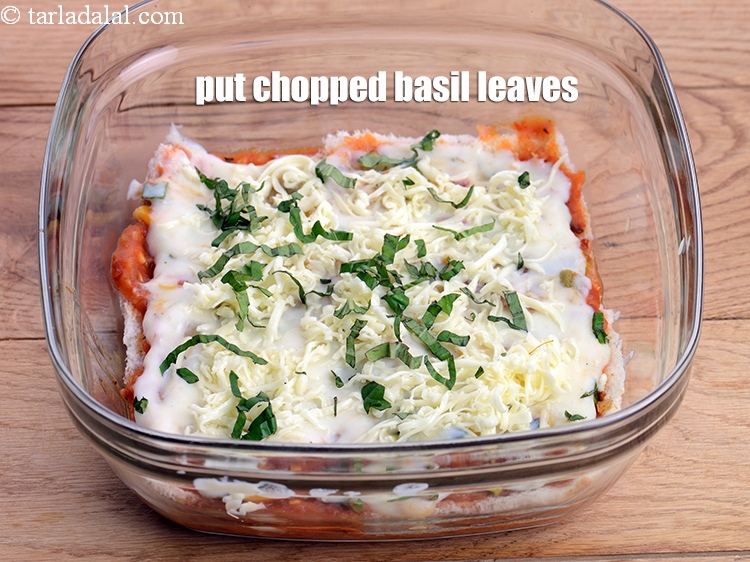 Step 52 – Put &frac12; tbsp chopped basil leaves evenly over it.<br /> &nbsp;