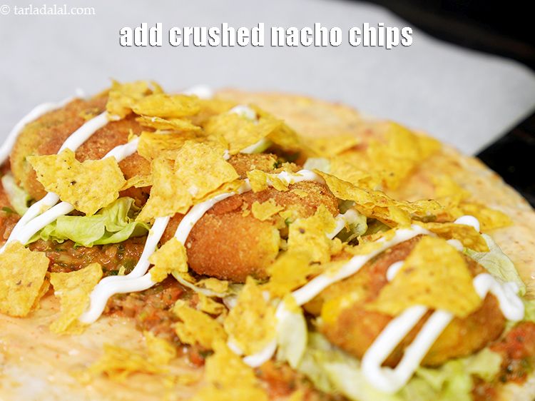 Step 52 – Add 2 tbsp <a href="https://www.tarladalal.com/glossary-crushed-nacho-chips-or-tortilla-chips-2443i">crushed nacho chips</a>.&nbsp;