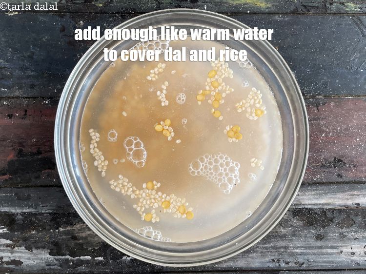 Step 7 – Add&nbsp;<strong>enough lukewarm water</strong> to cover the dal and rice.