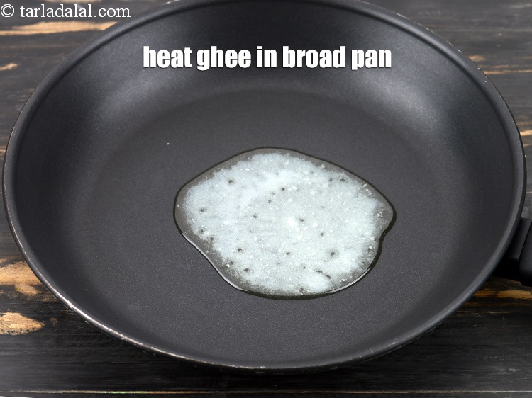 Step 6 – Heat 1 tbsp <a href="https://www.tarladalal.com/glossary-ghee-245i">ghee</a> in a broad non-stick pan.