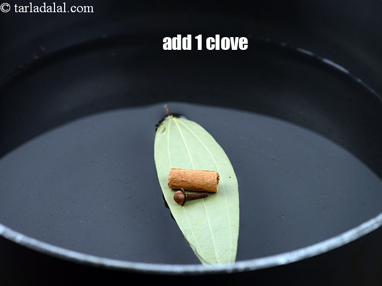 Step 8 – Add 1 <a href="https://www.tarladalal.com/glossary-cloves-laung-lavang-322i">cloves (laung / lavang)</a>.