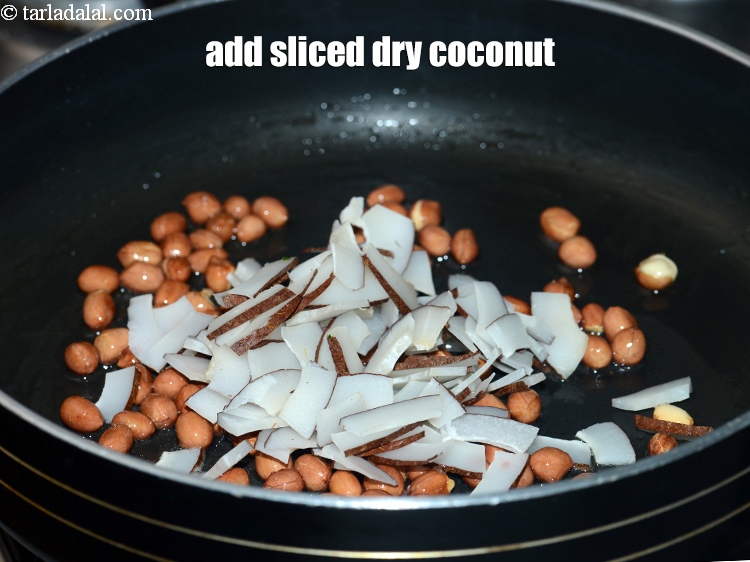Step 6 – Add &frac12; cup <a href="https://www.tarladalal.com/glossary-sliced-dry-coconut-2273i">sliced dry coconut (kopra)</a>.