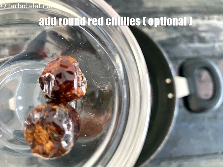 Step 22 – Add 2&nbsp;small&nbsp;<a href="https://tarladalal.com/glossary-round-red-chillies-boriya-chilli-boria-mirch-1096i">round red chillies (boriya mirch)</a>.
