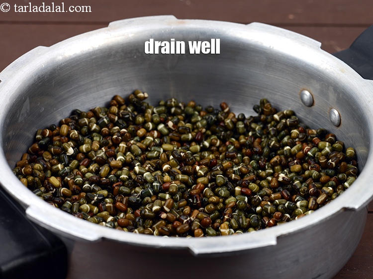 Step 6 – Drain well. In a pressure cooker, add soaked whole urad.