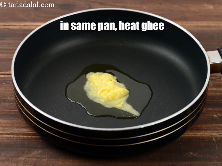 Step 8 – In the same broad non-stick pan, heat 2 tbsp <a href="https://www.tarladalal.com/glossary-ghee-245i">ghee</a>.