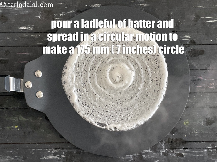 Step 68 – Pour a ladleful of the batter on it and spread it in a circular motion …