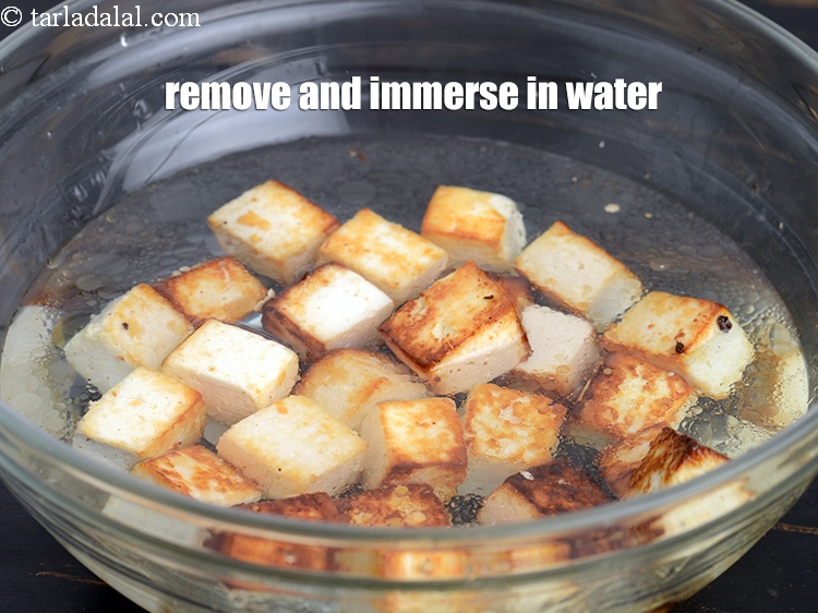 Step 6 – Remove the paneer cubes and immediately immerse them in water.
