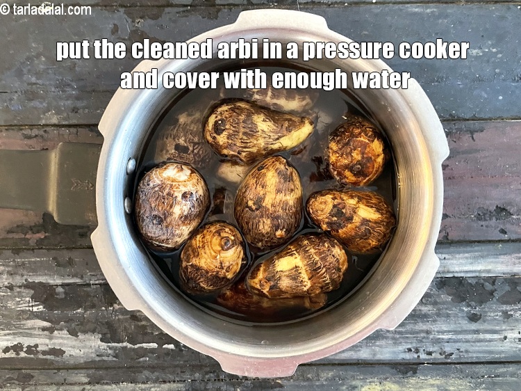 Step 8 – Put the cleaned arbi in a pressure cooker and cover with enough water.