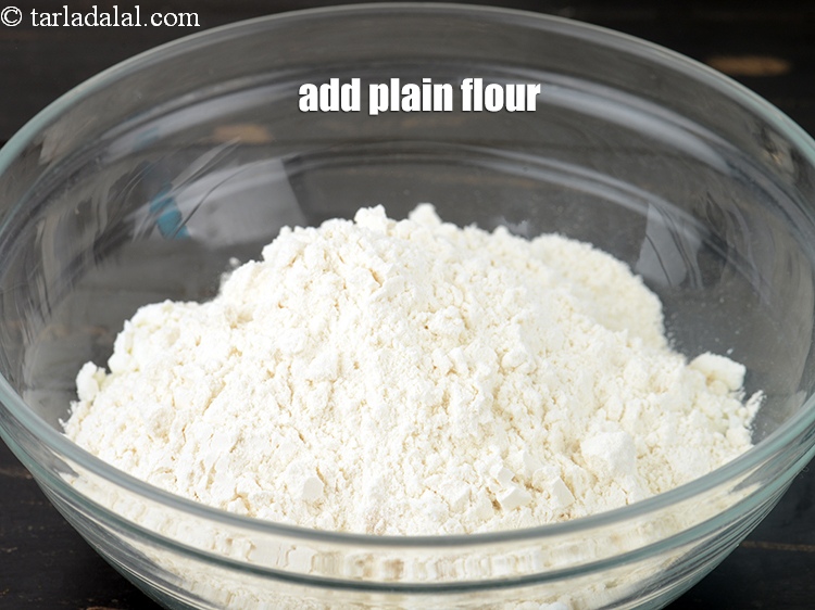 Step 6 – Add 1/2 cup <a href="https://www.tarladalal.com/glossary-plain-flour-maida-188i">plain flour (maida)</a>.