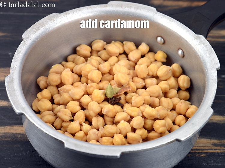 Step 7 – Add 2 <a href="https://tarladalal.com/glossary-cardamom-elaichi-262i">cardamoms (elaichi)</a>.