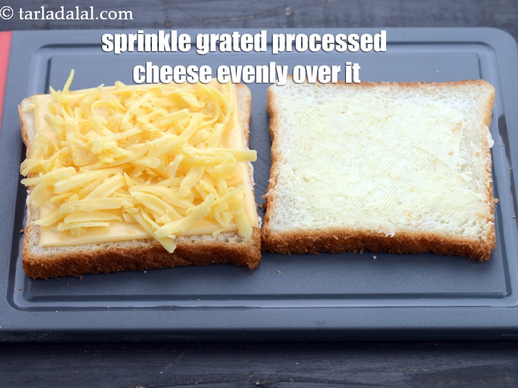Step 6 – Sprinkle 2 tbsp <a href="https://www.tarladalal.com/glossary-grated-processed-cheese-868i">grated processed cheese</a> evenly over it.