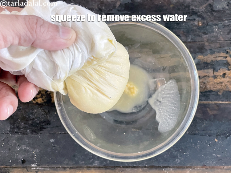 Step 13 – Squeeze to remove excess water.&nbsp;This helps us cook the moong dal halwa quickly.