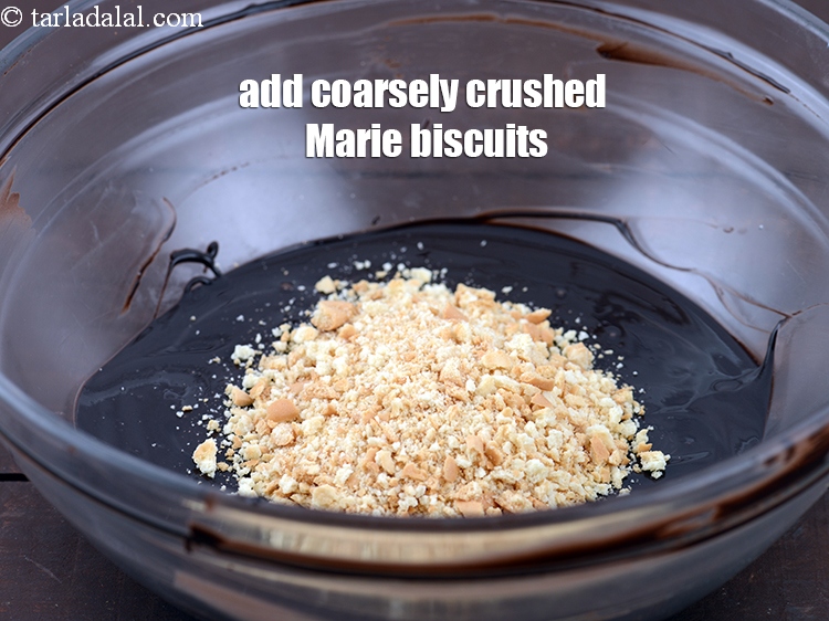 Step 6 – Add 1/4 cup coarsely <a href="https://www.tarladalal.com/glossary-crushed-marie-biscuit-2435i">crushed marie biscuits</a>.