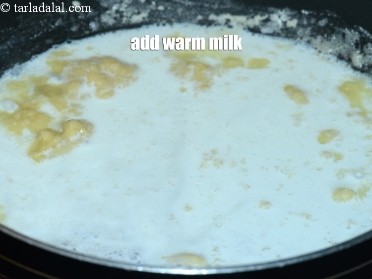 Step 6 – Add 1/4 cup warm <a href="https://www.tarladalal.com/glossary-milk-doodh-full-cream-milk-514i">milk</a>.