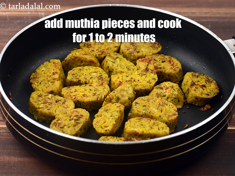 Step 26 – Add the muthia pieces, mix well and cook on a medium flame for 1 to …