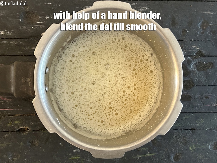 Step 9 – With help of a hand blender, blend the dal till smooth