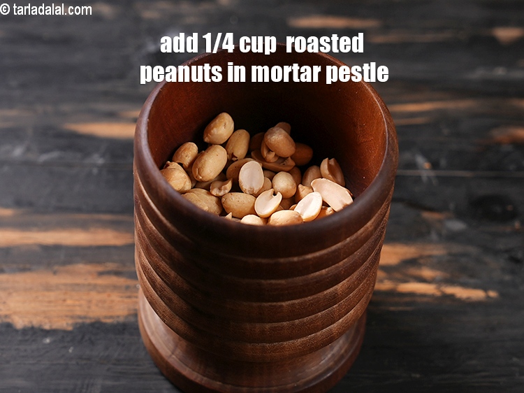 Step 7 – Transfer 1/4 cup of roasted peanuts in a mortar pestle.