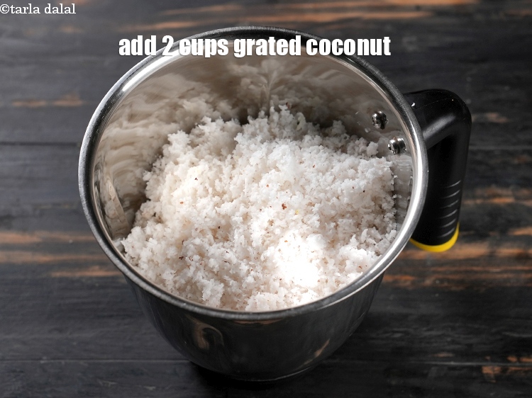 Step 7 – In a mixer add 2 cups <a href="https://www.tarladalal.com/glossary-grated-coconut-852i">grated coconut</a>.