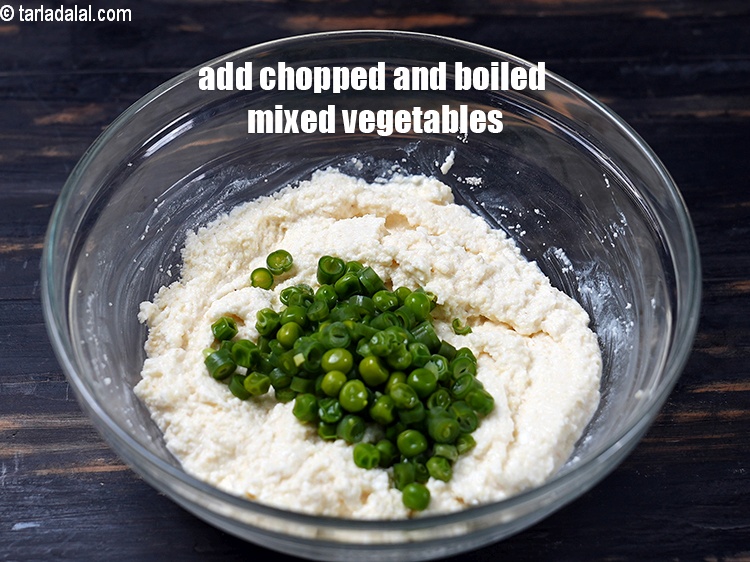 Step 8 – Add &frac14; cup <a href="https://www.tarladalal.com/glossary-chopped-and-boiled-mixed-vegetables-1884i">chopped and boiled mixed vegetables</a>.