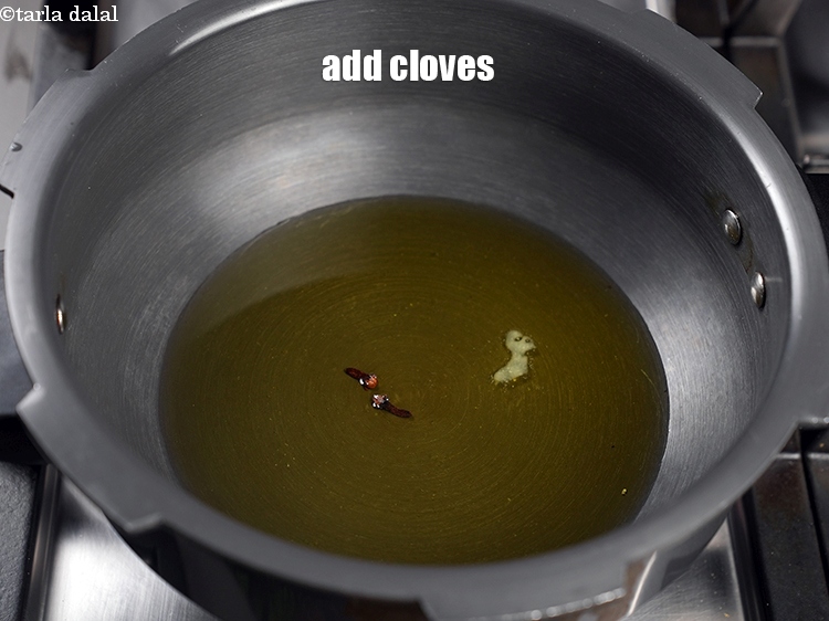 Step 7 – Add 3 <a href="https://www.tarladalal.com/glossary-cloves-laung-lavang-322i">cloves (laung / lavang)</a>.