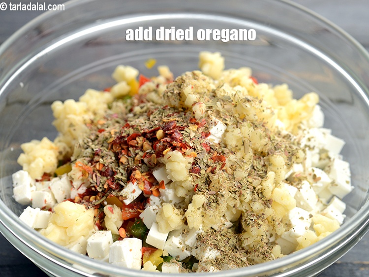 Step 7 – Add 1 tsp <a href="https://www.tarladalal.com/glossary-dried-oregano-268i">dried oregano</a>.