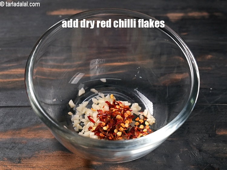 Step 7 – Add &frac12; tsp <a href="https://www.tarladalal.com/glossary-dry-red-chilli-flakes-paprika-338i">dry red chilli flakes (paprika)</a>.