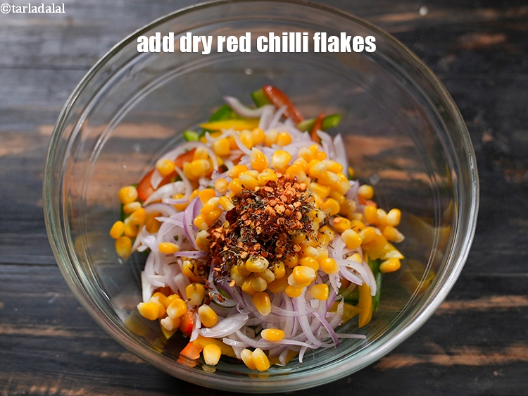 Step 7 – Add 1/2 tsp <a href="https://www.tarladalal.com/glossary-dry-red-chilli-flakes-paprika-338i">dry red chilli flakes (paprika)</a>.