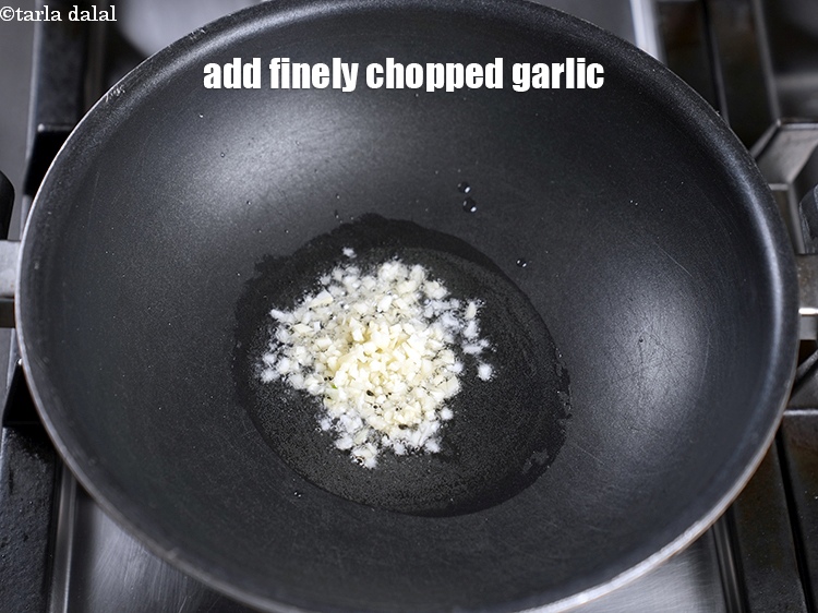 Step 12 – Add 2 tsp finely <a href="https://www.tarladalal.com/glossary-chopped-garlic-790i">chopped garlic (lehsun)</a>.
