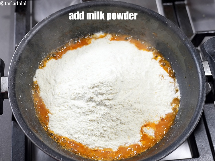 Step 7 – Add 2 cups <a href="https://www.tarladalal.com/glossary-milk-powder-517i">milk powder</a>.