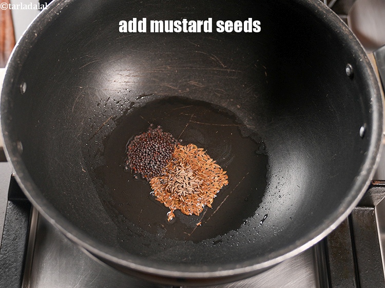 Step 7 – Add &frac12; tsp <a href="https://www.tarladalal.com/glossary-mustard-seeds-sarson-rai-sarson-ke-beej-525i">mustard seeds ( rai / sarson)</a>.