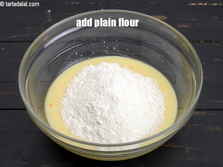 Step 8 – Add 1 cup&nbsp;<a href="https://www.tarladalal.com/glossary-plain-flour-maida-188i">plain flour (maida)</a>.