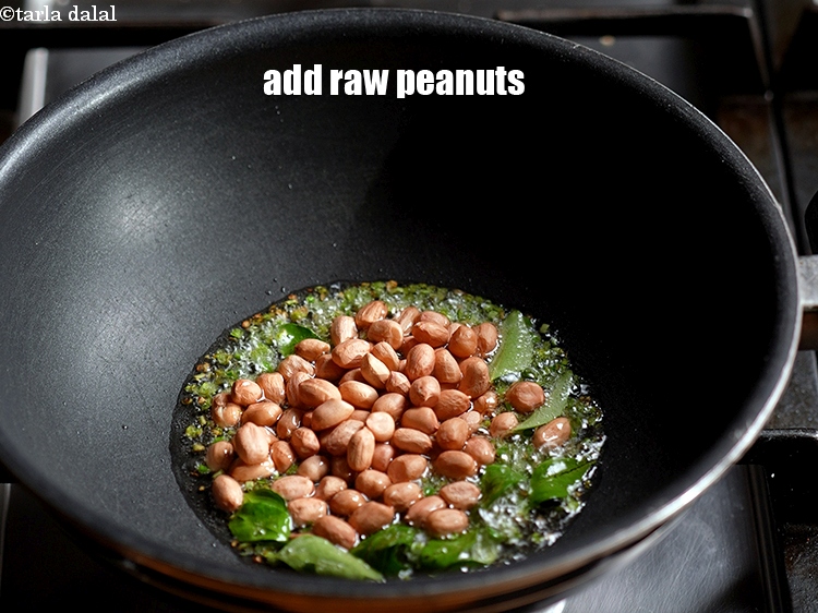 Step 7 – Add &frac14; cup <a href="https://www.tarladalal.com/glossary-raw-peanuts-kachi-mungfali-kachi-moongfali-847i">raw peanuts</a>.