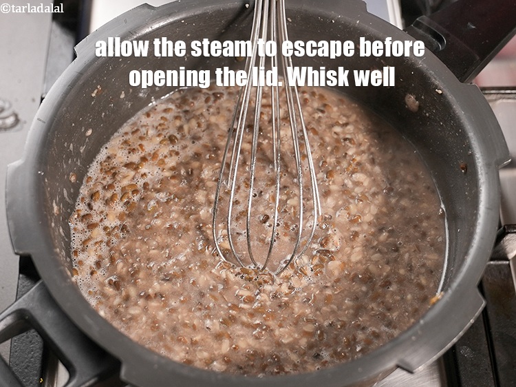 Step 7 – Allow the steam to escape before opening the lid. Whisk well and keep aside.