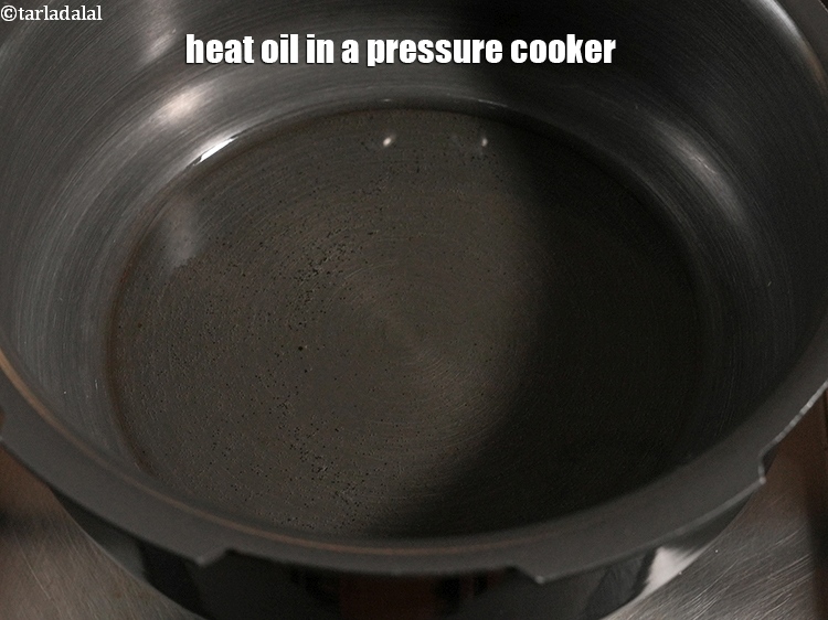 Step 7 – Heat 3 tbsp <a href="https://www.tarladalal.com/glossary-oil-671i">oil</a> in a pressure cooker.