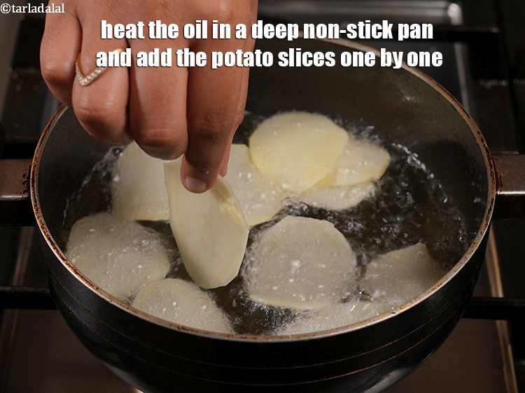 Step 8 – Heat the oil in a deep non-stick pan and add the potato slices one by …