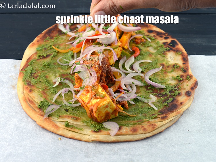 Step 58 – Sprinkle little <a href="https://www.tarladalal.com/glossary-chaat-masala-300i">chaat masala</a>&nbsp;for sprinkling evenly over it.