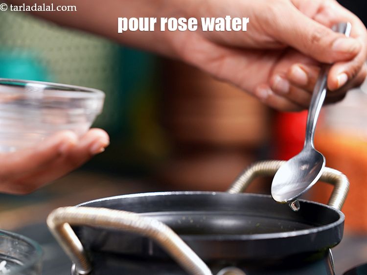Step 55 – Pour 2&nbsp;tbsp&nbsp;<a href="https://www.tarladalal.com/glossary-rose-water-gulab-jal-649i">rose water</a>&nbsp;(gulab jhal) evenly over it.