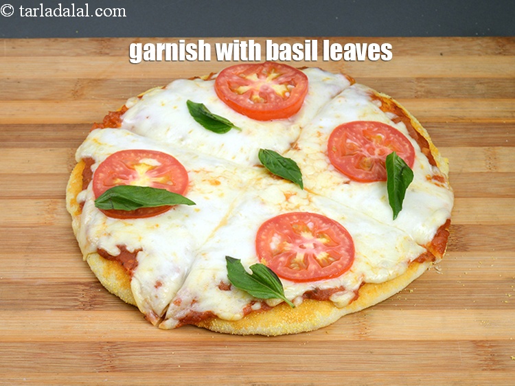 Step 54 – Garnish with <a href="https://www.tarladalal.com/glossary-basil-185i">basil</a>&nbsp;leaves&nbsp;.