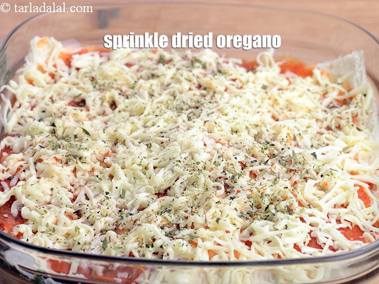 Step 56 – Sprinkle &frac12; tsp <a href="https://www.tarladalal.com/glossary-dried-oregano-268i">dried oregano</a>.