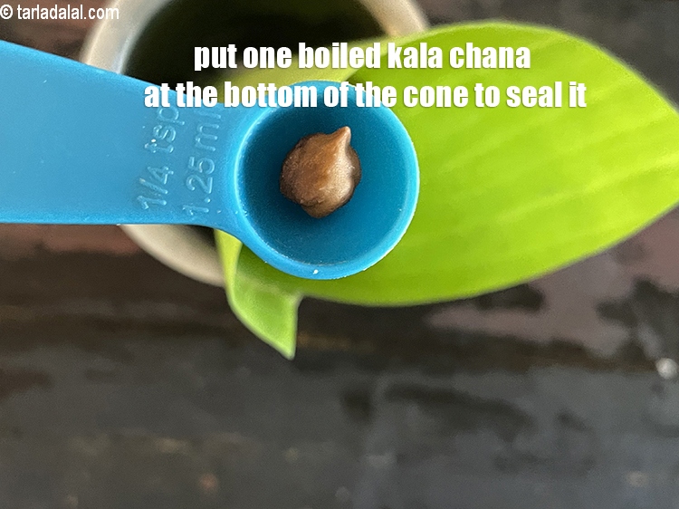 Step 55 – Put one boiled kala chana at the bottom of the cone to seal it.