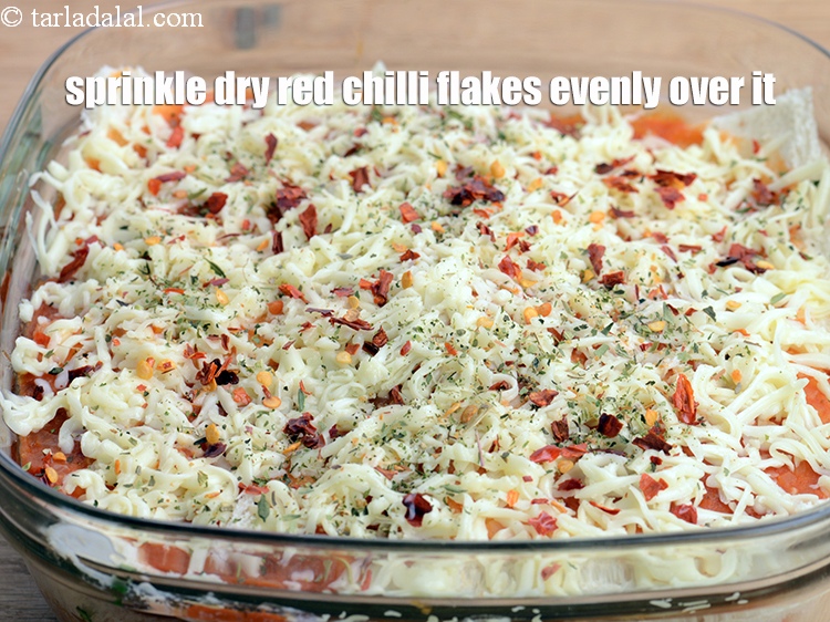 Step 57 – Sprinkle 1 tsp <a href="https://www.tarladalal.com/glossary-dry-red-chilli-flakes-paprika-338i">dry red chilli flakes (paprika)</a> evenly over it.