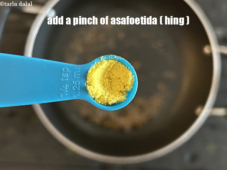Step 12 – Add&nbsp;<meta charset="UTF-8" />a pinch of&nbsp;<a href="glossary-asafoetida-hing-113i">asafoetida (hing)</a>.