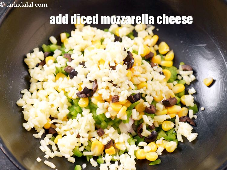 Step 7 – Add 1/2 cup <a href="https://www.tarladalal.com/glossary-diced-mozzarella-cheese-2805i">diced mozzarella cheese</a>.