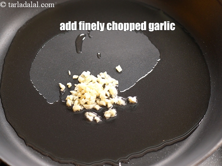 Step 7 – Add 2 tsp finely <a href="https://www.tarladalal.com/glossary-chopped-garlic-790i">chopped garlic (lehsun)</a>.