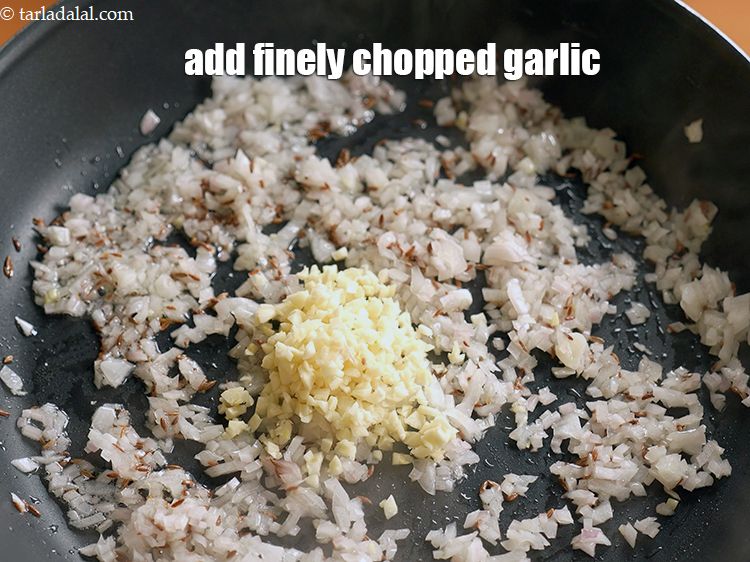 Step 7 – Add 2 tbsp finely <a href="https://www.tarladalal.com/glossary-chopped-garlic-790i">chopped garlic (lehsun)</a>.
