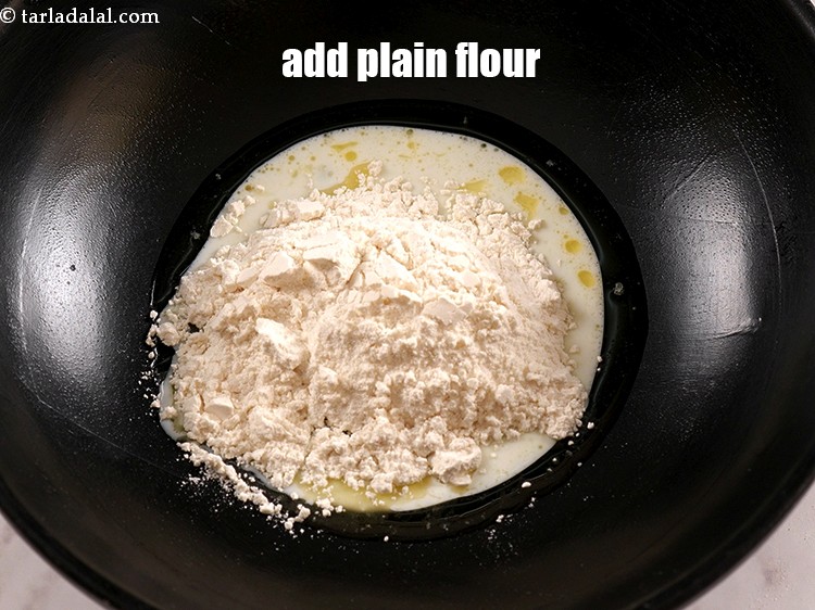 Step 7 – Add 1/4 cup <a href="https://www.tarladalal.com/glossary-plain-flour-maida-188i">plain flour (maida)</a>.