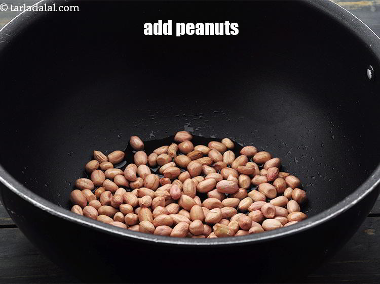 Step 6 – Add the <a href="https://www.tarladalal.com/glossary-raw-peanuts-kachi-mungfali-kachi-moongfali-847i" target="_blank">peanuts</a>.