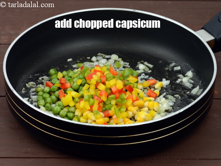 Step 7 – Add 1/2 cup&nbsp;chopped capsicum (<a href="https://tarladalal.com/glossary-chopped-red-capsicum-2299i">red</a>&nbsp;,&nbsp;<a href="https://tarladalal.com/glossary-chopped-yellow-capsicum-2300i">yellow</a>&nbsp;and&nbsp;<a href="https://tarladalal.com/glossary-chopped-capsicum-164i">green</a>). This gives a nice eye appeal.&nbsp;